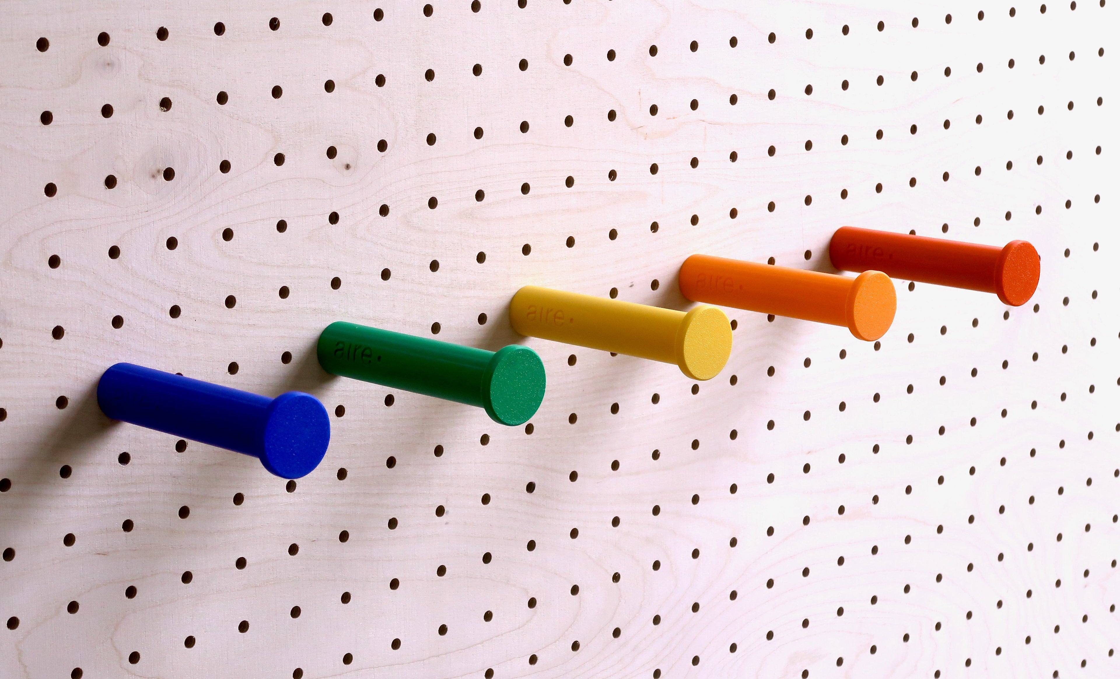 Robust modular pegboard with colorful plug and play hooks for stylish home organization and storage accessories.
